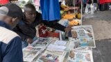 A newspaper vendor arranges newspapers that headlines electoral news following Kenya's general election at a newsstand in Nairobi, Aug. 10, 2022.