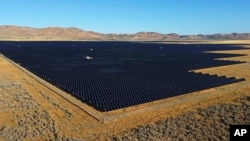 A solar farm sits Aug. 9, 2022, in Mona, Utah. The Biden Administration seeks to accelerate the expansion of clean energy such as wind and solar power, speeding the transition away from fossil fuels that largely cause climate change. AP Photo/Rick Bowmer