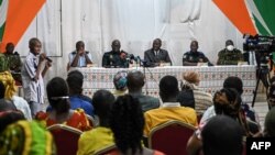 FILE - Ivory Coast officials address the relatives of the 49 Ivorian soldiers detained in Mali, in Abidjan, Aug. 3, 2022.