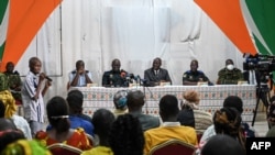FILE - Ivory Coast officials address the relatives of the 49 Ivorian soldiers detained in Mali, in Abidjan,. Taken 8.3.2022