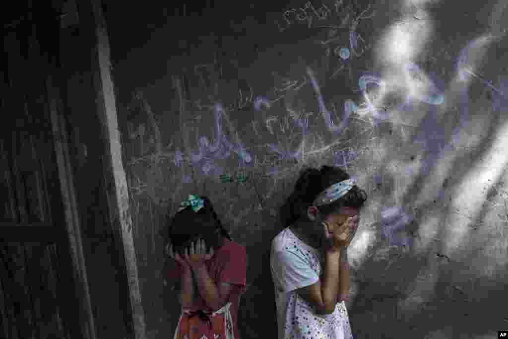 Palestinian girls react during the funeral of 11-year-old Layan al-Shaer in Khan Younis, in the Gaza Strip. Al-Shaer&nbsp;died of her wounds after she was injured in last week&#39;s Israeli airstrikes.