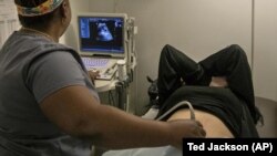 FILE - A technician performs an ultrasound on a pregnant patient in Shreveport, La., Wednesday, July 6, 2022. (AP Photo/Ted Jackson, File)