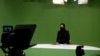 FILE - Masheed Barzz, an Afghan presenter for 1TV channel, appears on camera with her face covered by a veil, in Kabul on May 25, 2022. The Taliban have mandated that female news presenters and guests cover their faces except for the eyes on television.