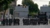 Riot police stand guard outside Government House in Bangkok, Aug. 24, 2022. Thailand's Constitutional Court ruled Wednesday that PM Prayuth Chan-ocha must suspend his active duties while the court decides whether he has overstayed his legal term in office