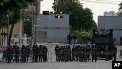 Riot police stand guard outside Government House in Bangkok, Aug. 24, 2022. Thailand's Constitutional Court ruled Wednesday that PM Prayuth Chan-ocha must suspend his active duties while the court decides whether he has overstayed his legal term in office