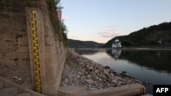The water level gauge in Kaub, western Germany, is seen on Aug.12, 2022, as the level of the Rhine river passed below 40 centimeters, making ship transport increasingly difficult.
