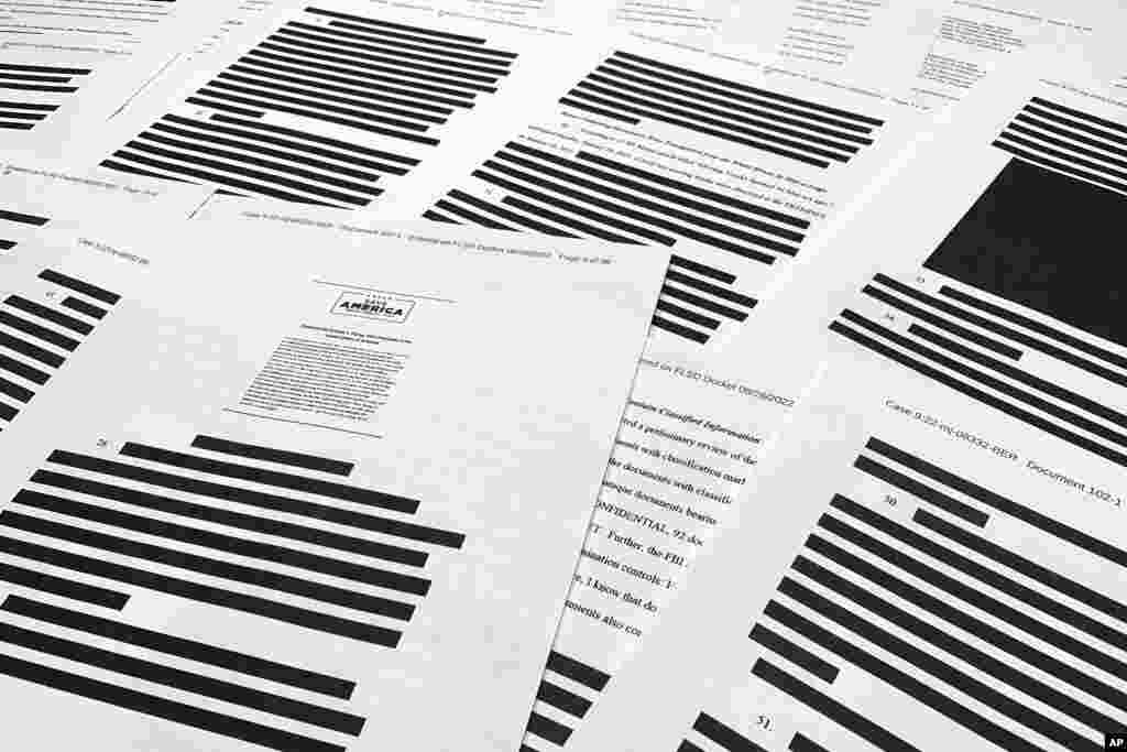 Pages from the affidavit by the FBI in support of obtaining a search warrant for former President Donald Trump&#39;s Mar-a-Lago estate are photographed. U.S. Magistrate Judge Bruce Reinhart ordered the Justice Department to make public a redacted version of the affidavit it relied on when federal agents searched Trump&#39;s estate to look for classified documents.