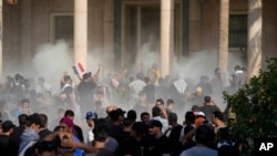 Iraqi security forces fire tear gas on the followers of Shiite cleric Muqtada al-Sadr inside the government Palace, Baghdad, Iraq, Aug. 29, 2022.