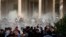 Iraqi security forces fire tear gas on the followers of Shiite cleric Muqtada al-Sadr inside the government Palace, Baghdad, Iraq, Aug. 29, 2022.