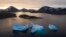 FILE - Large icebergs float away as the sun rises near Kulusuk, Greenland, Aug. 16, 2019. 