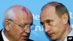 FILE - Russia's President Vladimir Putin, right, talks with former Soviet President Mikhail Gorbachev at the start of a news conference at the Castle of Gottorf in Schleswig, northern Germany, Dec. 21, 2004.