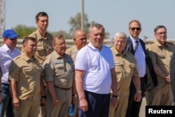Head of the Roscosmos space agency Yuri Borisov, center, attends a ceremony to launch a Soyuz-2.1b rocket booster with the Iranian satellite "Khayyam" at the Baikonur Cosmodrome, Kazakhstan, Aug. 9, 2022. (Roscosmos/Handout via Reuters)