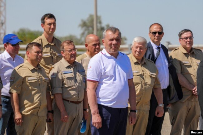Head of the Roscosmos space agency Yuri Borisov, center, attends a ceremony to launch a Soyuz-2.1b rocket booster with the Iranian satellite "Khayyam" at the Baikonur Cosmodrome, Kazakhstan, Aug. 9, 2022. (Roscosmos/Handout via Reuters)