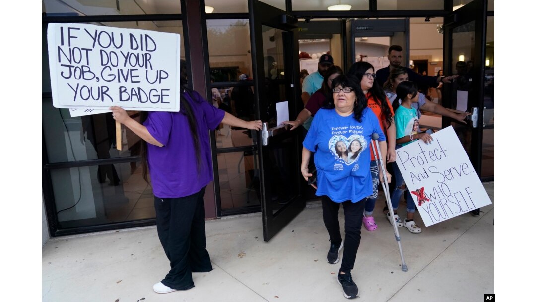 FILE - Family, parents and friends file out of a meeting where Uvalde School District Police Chief Pete Arredondo was dismissed by the Board of Trustees of the Uvalde Consolidated Independent School District, in Uvalde, Texas, Aug. 24, 2022.