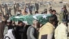 FILE - Relatives and local residents carry the coffin of a slain policeman, who was killed in an attack claimed by the Tehrik-i-Taliban Pakistan (TTP), during his funeral in the border town of Chaman, Jan. 28, 2022.