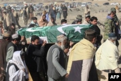 FILE - Relatives and local residents carry the coffin of a slain policeman, who was killed in an attack claimed by the Tehreek-e-Taliban Pakistan (TTP), during his funeral in the border town of Chaman, Jan. 28, 2022.