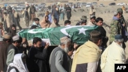 FILE - Relatives and local residents carry the coffin of a slain policeman, who was killed in an attack claimed by the Tehrik-i-Taliban Pakistan (TTP), during his funeral in the border town of Chaman, Jan. 28, 2022.