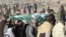 FILE - Relatives and local residents carry the coffin of a slain policeman, who was killed in an attack claimed by the Tehrik-i-Taliban Pakistan (TTP), during his funeral in the border town of Chaman, Jan. 28, 2022.