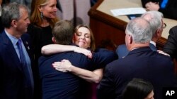 Members of the House of Representatives celebrate after the vote to approve the Inflation Reduction Act in the House chamber at the Capitol in Washington, Aug. 12, 2022.