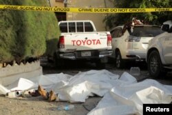 FILE - The bodies of al-Shabab militants lie outside the Hayat Hotel in Mogadishu, Somalia, Aug. 21, 2022.