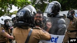 FILE - University students clash with police during a demonstration in Colombo, Sri Lanka.