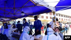 People queue to be tested for the COVID-19 coronavirus in Lhasa, in China's western Tibet Autonomous Region, Aug. 9, 2022.