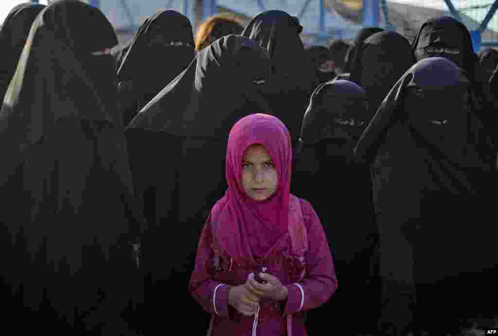 People gather in the Kurdish-run al-Hol camp, which holds relatives of suspected Islamic State group fighters in the northeastern Hasakeh governorate, during a security operation by the Kurdish Asayish security forces and the special forces of the Syrian Democratic Forces.