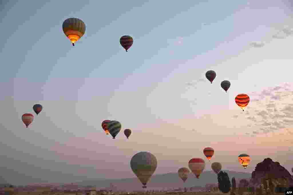 Sight-seeing hot air balloons launch in Goreme Historical National Park, east of Nevesehir (Neapolis) in central Turkey&#39;s historical Cappadocia (Kapadokya) region, Aug. 24, 2022.