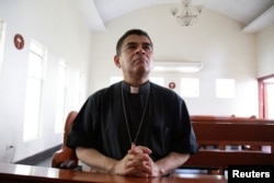 FILE - Rolando Alvarez, bishop of the Diocese of Matagalpa and Esteli and critical of the Nicaraguan President Daniel Ortega, prays at a Catholic church in Managua, Nicaragua, May 20, 2022.