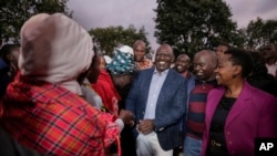 Deputy President and presidential candidate William Ruto, center, greets supporters after casting his vote in Kenya's general election in Sugoi, 50 kms (35 miles) north west of Eldoret, Kenya, Aug. 9, 2022