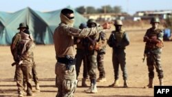 FILE - A French Marine Special Operation Forces officer trains Mali's FAMA soldiers, December 15, 2021. 