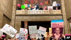 FILE - Supporters of abortion rights rally against recently passed restrictions on abortions in the Statehouse rotunda Tuesday, May 21, 2019, at the Nebraska Capitol in Lincoln, Nebraska.