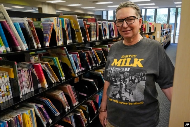Gretchen Robinson, a lesbian high school teacher in Orange County, Fla., poses for a photo at the downtown library, Saturday, Aug. 13, 2022, in Orlando, Fla. (AP Photo/John Raoux)