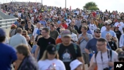 Spectators leave the Max Brewer Bridge after a scrub of the launch of the Artemis I mission to orbit the moon at the Kennedy Space Center, Aug. 29, 2022, in Titusville, Fla. 