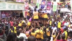 Indian Devotees Form Human Pyramids as They Daub in Colors 