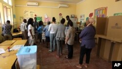 FILE - Voters queue to cast their votes at a polling station in general elections, in Luanda, Angola, Aug. 23, 2017. 