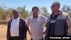 Zephania Dhlamini, Siphosami Malunga and Charles Moyo outside Tsholotsho Magistrates' Court