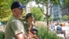 FILE - Army Staff Sgt. Jeff Deslauriers, left, listens as names of Sept. 11 victims are read, Sept. 11, 2021, in New York. A U.S. judge on Aug. 26, 2022, recommended that 9/11 victims not be allowed to seize Afghan central bank assets to satisfy judgments against the Taliban.