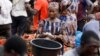 FILE - A woman counts money at Mile 12 International Market in Lagos, Nigeria, May 13, 2022.