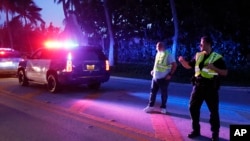 FILE - Police direct traffic outside an entrance to former President Donald Trump's Mar-a-Lago estate, Aug. 8, 2022, in Palm Beach, Fla., as the FBI conduct a search.