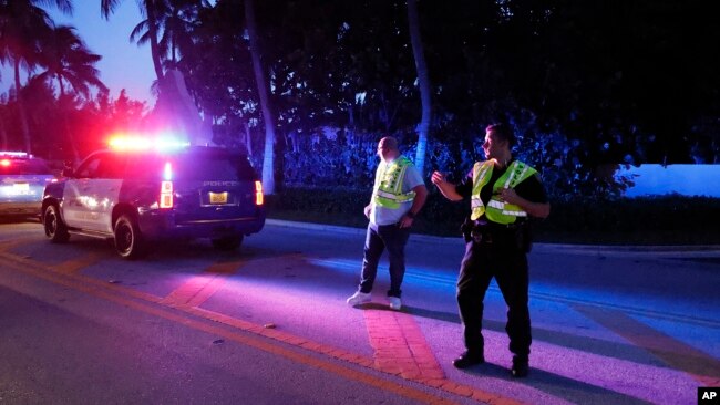 FILE - Police direct traffic outside an entrance to former President Donald Trump's Mar-a-Lago estate, Aug. 8, 2022, in Palm Beach, Fla., as the FBI conduct a search.