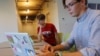 Hlib Burtsev and Oleksii Shebanov, both from Ukraine, check their email in the common area of their dorm ahead of their first year at Brown University in Providence, Rhode Island, U.S., August 16, 2022. (REUTERS/Brian Snyder)