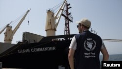 A World Food Program staff member looks on as the MV Brave Commander carrying wheat grain from Yuzhny Port in Ukraine to the drought-stricken Horn of Africa docks in Djibouti, Aug. 30, 2022. (Hugh Rutherford/World Food Program/Handout via Reuters) 