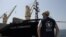 A World Food Program staff member looks on as the MV Brave Commander carrying wheat grain from Yuzhny Port in Ukraine to the drought-stricken Horn of Africa docks in Djibouti, Aug. 30, 2022. (Hugh Rutherford/World Food Program/Handout via Reuters) 