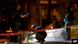 Israeli police crime scene investigators work at the scene of a shooting attack that wounded several Israelis near the Old City of Jerusalem, Aug. 14, 2022.