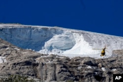 FILE - A rescue helicopter flies over the Punta Rocca glacier near Canazei, in the Italian Alps in northern Italy, Wednesday, July 6, 2022. (AP Photo/Luca Bruno, File)