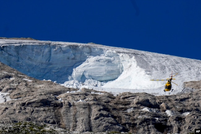 FILE - A rescue helicopter flies over the Punta Rocca glacier near Canazei, in the Italian Alps in northern Italy, Wednesday, July 6, 2022. (AP Photo/Luca Bruno, File)