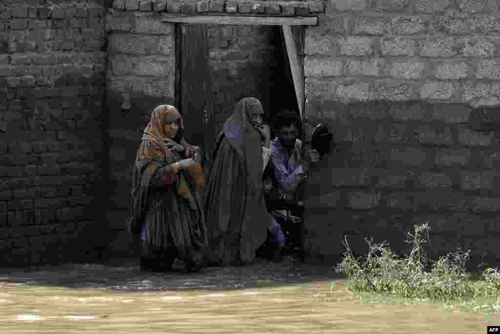 Stranded residents prepare to leave their flooded home following heavy monsoon rains in Charsadda district of Khyber Pakhtunkhwa, Pakistan.