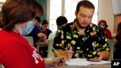 Angel Hope works on a math problem, part of an intense six-week summer bridge program for students of color and first-generation students at the University of Wisconsin, in Madison, Wis., July 27, 2022. (AP Photo/Carrie Antlfinger)