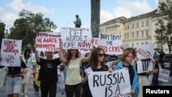 Activists, relatives and friends of defenders of the Azovstal Iron and Steel Works in Mariupol hold a rally to their support, as Russia's attack on Ukraine continues, in central Lviv, Ukraine, Aug. 18, 2022. 